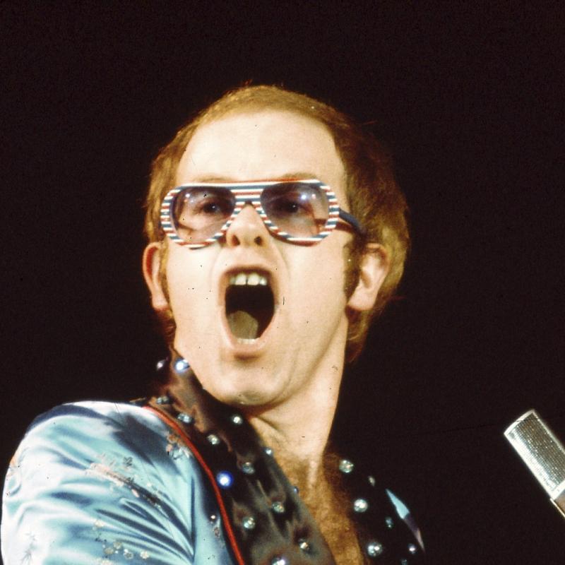 Sir Elton John performs at his piano during this concert shot taken in 1973