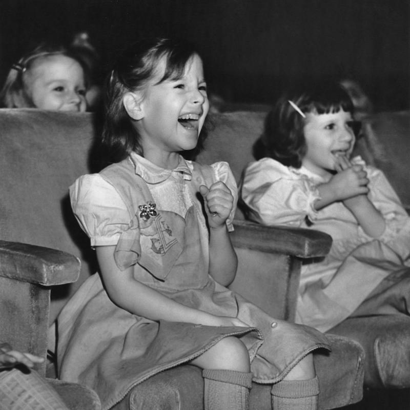Little girls laughing in an audience