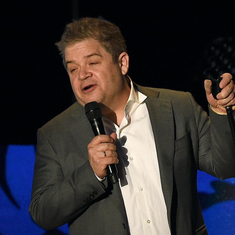 Comedian Patton Oswalt tells a joke on stage